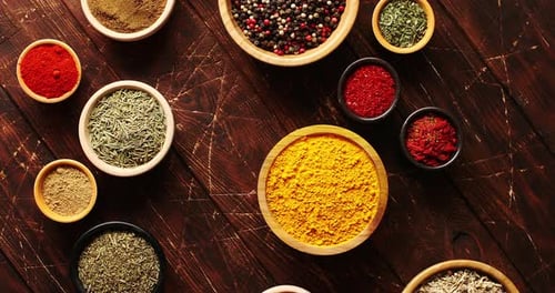 Various Spices Arranged in Bowls on Wood Table