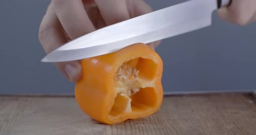 Orange Bell Pepper Sliced on Cutting Board