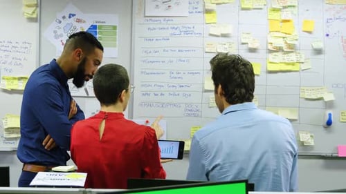 Colleagues Brainstorming Data in Office Workplace