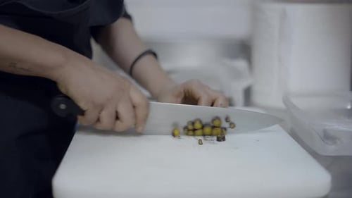 Close Side View of Chef Slicing Vegetables on Kitchen Counter No Face