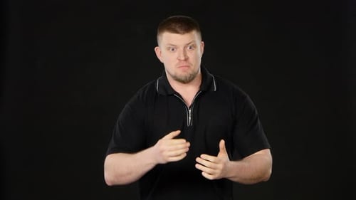 Man Speaking and Gesturing with Exaggerated Positive Emotion