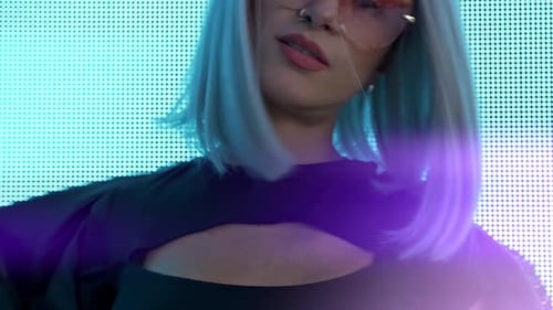 Stylish Woman Posing in Front of Bright Screen