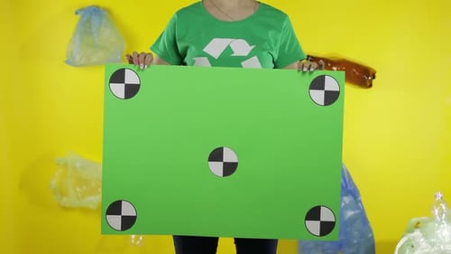 Unrecognizable Woman Holding Chroma Key Poster with Tracking Points. Environment Plastic Pollution
