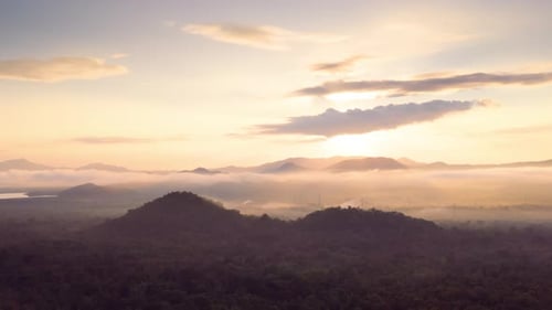 Majestic Mountains and Drifting Mist at Sunrise