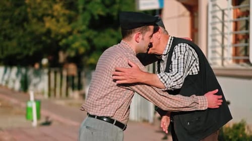 Men Embrace on City Street