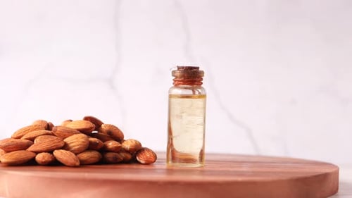 Almond Oil in Bottle on Wooden Background. Close Up
