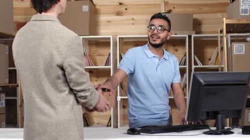 Man Receiving Package While Working at Computer