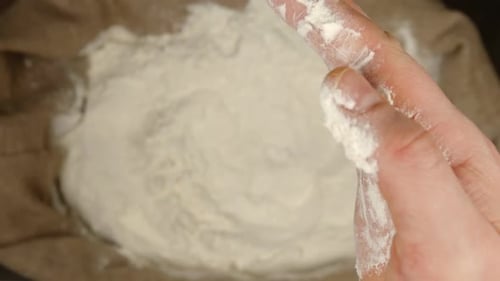 Hand Holding Flour, Close-Up Baking Ingredient