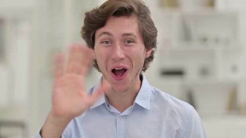 Young Man Smiling and Waving Hello