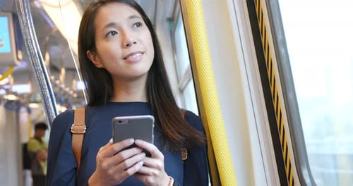 Woman Using Smartphone on Train
