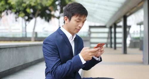 Young Adult Using Smartphone in Urban Setting