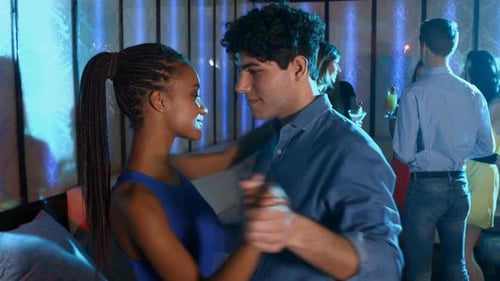 Young Couple Dancing at Nightclub Party with Friends