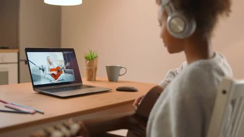 Girl Learning Guitar Online
