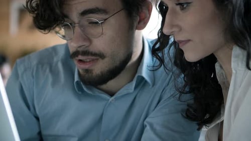 Focused Colleagues Work Together in Modern Office