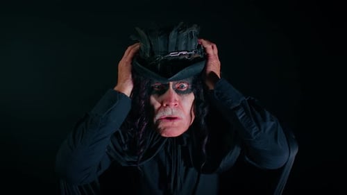 Frightening Senior Man with Halloween Witcher Makeup Raising Hands in Surprise Shocked By Victory