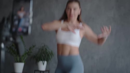 Woman Bouncing on Mini Trampoline Recording Video
