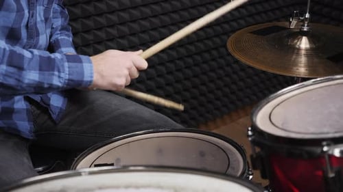 Drummer's hand is playing drum kit