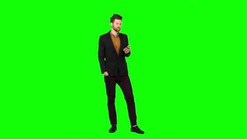 Guy Looks at the Phone in the Photo, and Has Fun. Green Screen