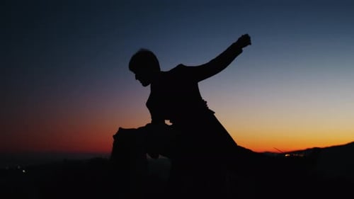 Silhouetted Couple Embracing at Sunset