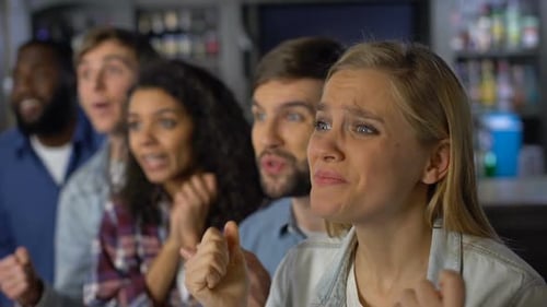 Friends Watching Sports at a Bar Cheering