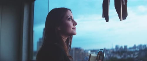 Woman Looks at City Through Vintage Camera