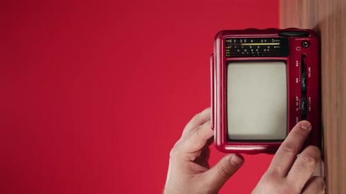 Red Television with Antenna Being Turned On