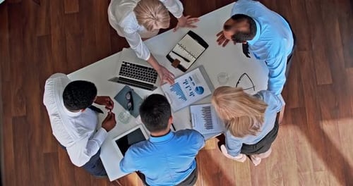Diverse Team Collaborating on Strategy in Corporate Office