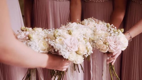 Closeup of 5 Bridesmaids Bouquets in Bridesmaids Hands on the Wedding Day