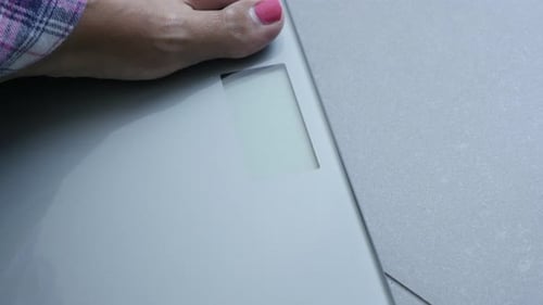 Silver digital health scale using in bathroom atmosphere 4K 2160p 30fps UltraHD footage - Close-up