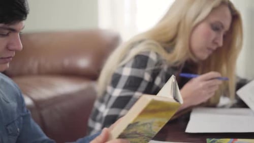 Students Reading Together at a Table Indoors