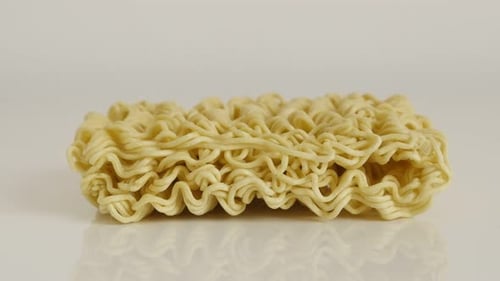 Close-up of Chinese type noodles 4K 2160p 30fps UltraHD tilting footage - Instant staple food block