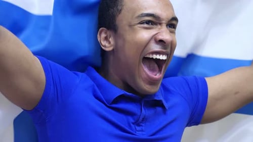 Man Cheers and Holds Flag