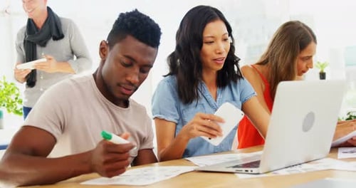 Business colleagues working on laptop in the office