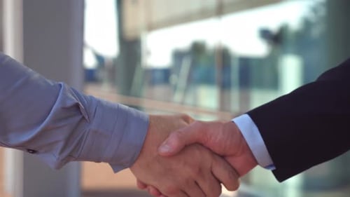 Close Up of Two Successful Businessmen Greeting Each Other in Urban Environment. Young Colleagues