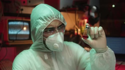 Researcher Holds Vial of Liquid in Lab