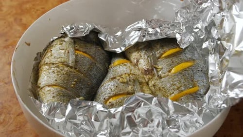 Preparing Fresh Fish With Lemon For Baking