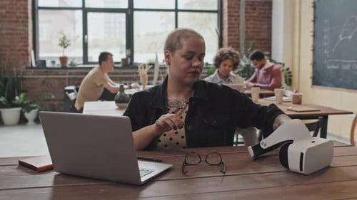 Woman Using VR Goggles in Office