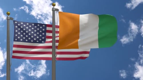 Flags of USA and Ivory Coast Waving Under Blue Sky