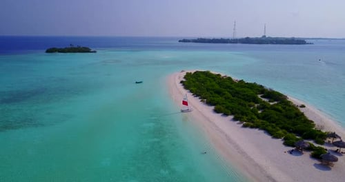 Wide above island view of a sandy white paradise beach and blue sea background in best quality 4K