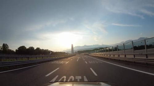 Sommer-Roadtrip durch Europa: Blick aus der ersten Person auf ein fahrendes Auto auf einer Autobahn und natürliche Brücken