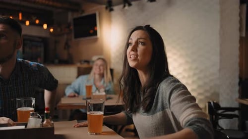 Friends Cheering and Celebrating Together in Bar