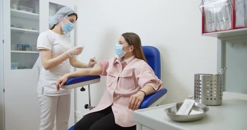 Medical Professional Preparing Injection in Hospital Setting