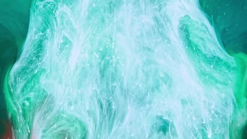 White fluid rushing through green liquid