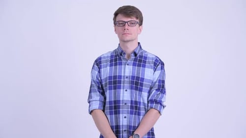 Young Man Waving and Smiling in Blue Shirt