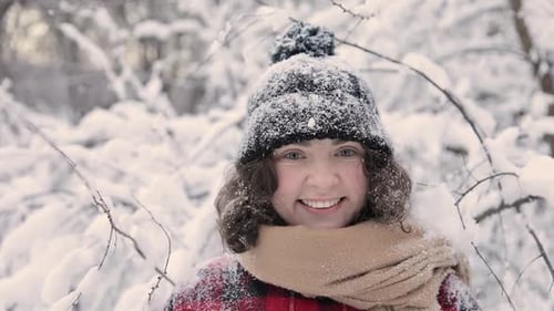 Portrait Of Cute Girl That Stands In The Snow Forest.