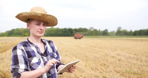 Young Farmer Using Tablet in Wheat Field