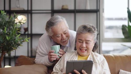 Senior Couple Relaxing at Home with Tablet