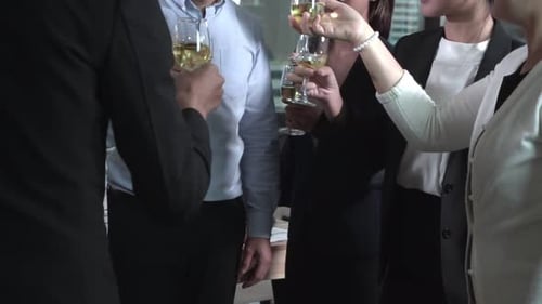 Celebrating Success: Colleagues Toasting with Champagne in Office