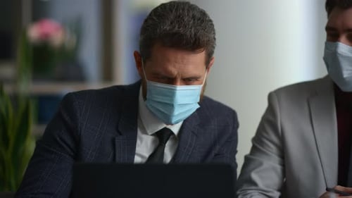 Diverse Managers Team Research Laptop Wear Face Mask in Modern Office Building