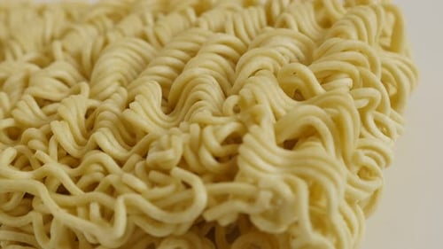 Panning on instant staple food block 4K 2160p 30fps UltraHD footage - Chinese type noodles close-u